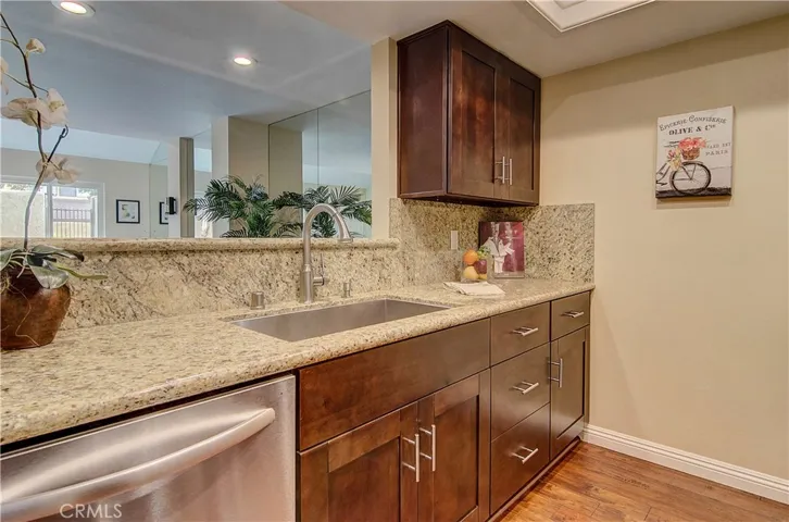 Rich wood cabinetry and beautiful granite counters add warmth and elegance.