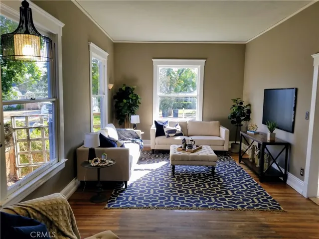 Large Living Room with Tall/High Ceilings, Gorgeous Original Windows, Wood Flooring, Baseboards, Trim and Crown Molding!