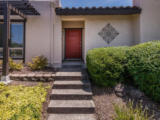 The front entry is sheltered and has a welcoming red door.
