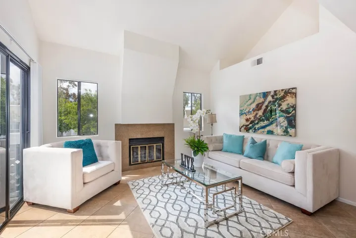 Plenty of room to get comfortable in this large, airy and bright living room. This room has it all, soaring cathedral ceilings, lots of windows and a updated Granite fireplace.