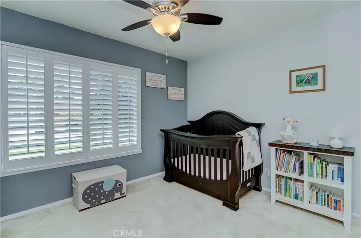 Kid's room has lovely plantation shutters and large wardrobe closet.