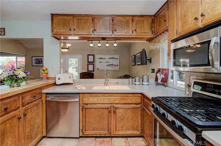 Nicely updated kitchen with stainless appliances and corian counters.