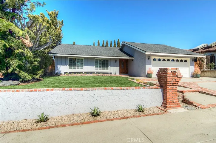 Elevated lot with sweeping fresh lawn and brick accents create nice curb appeal.