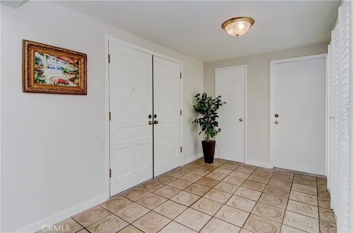 Huge entrance foyer has views to center atrium and very cool mid-century flooring.