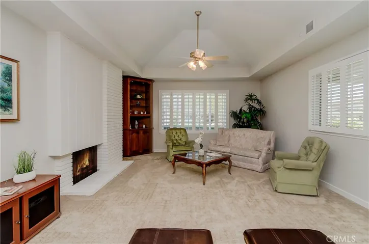 Cozy fireplace and nice ceiling details enhance the large living room.