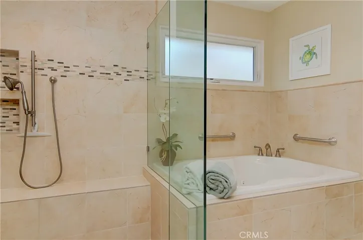 Check out these features...huge shower with shampoo niches, built-in bench seat, adjustable shower wand, jetted tub, and gorgeous tile detail...yep...five star quality here!
