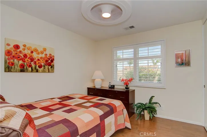 Roomy kids/guest room with cool ceiling fan, plantation shutters and large wardrobe closet.