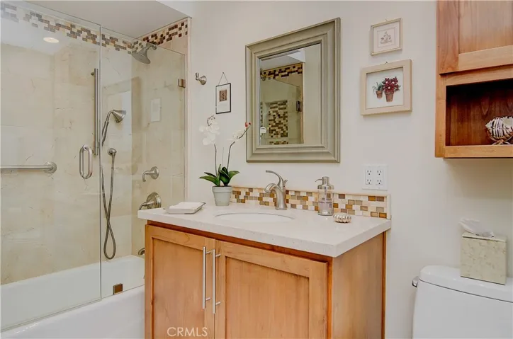 Sparkling hall bath has beautiful designer detaills including custom tile work and alder cabinetry.