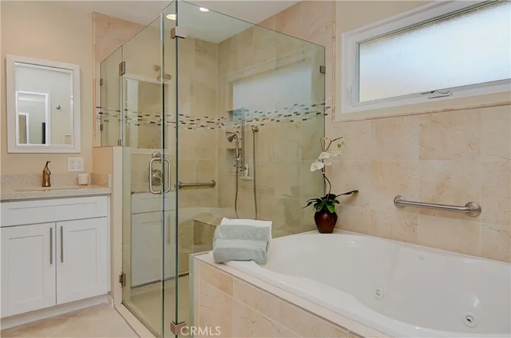 Feels like you are in a five star hotel in this incredible master bath with spa tub, huge shower and dual sink vanity.