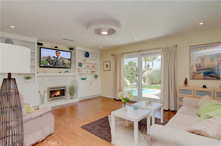 Large living room has it all...cozy fireplace with lovely facade, built-in cabinetry and slider to rear yard.