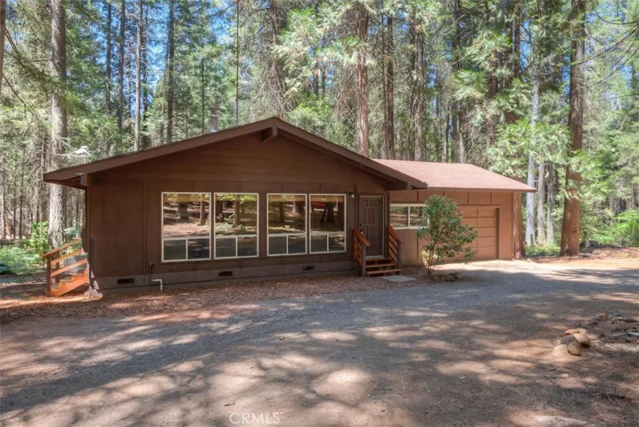 Absolutely wonderful mountain retreat. Home situated on a one beautiful acre of land, surrounded by large majestic trees. 2 Bedroom home with bonus room. High vaulted wood ceilings in Living, Dining and Kitchen. Cozy gas freestanding stove in living room. Laminate flooring in Kitchen and hallway, Newer dual pane windows in most rooms. Large circle drive with unlimited parking area including plenty of room for RV/Boat or any parking needs. Original family owned home. Home tucked away, on a flag lot off Fair