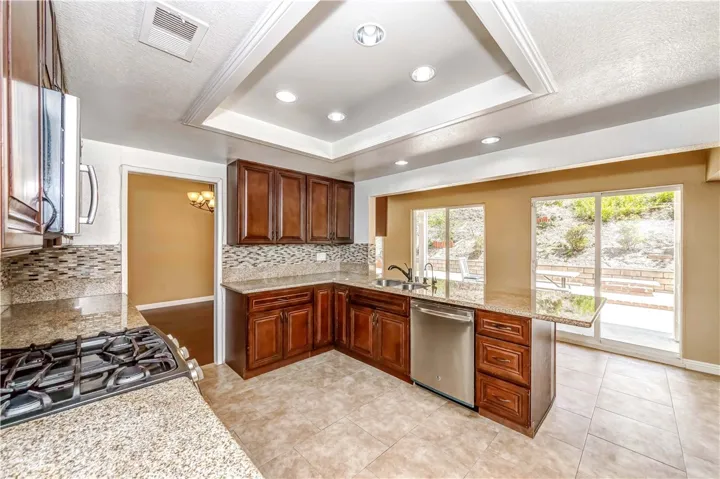 Kitchen opens to dining area, three patio doors to back yard