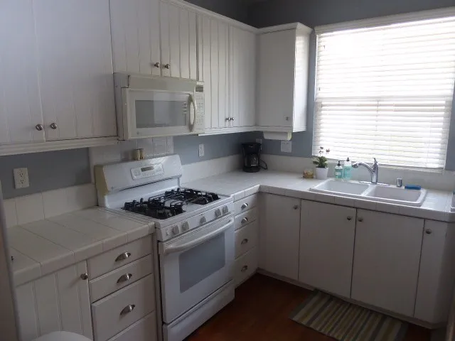 Range, microwave, and refrigerator are included.