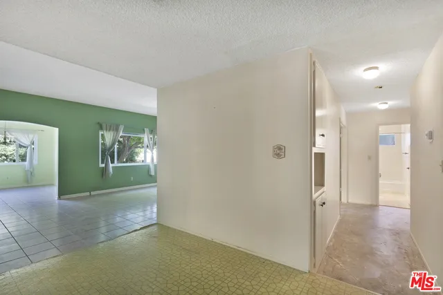 As is entry looking toward living/dining & hallway