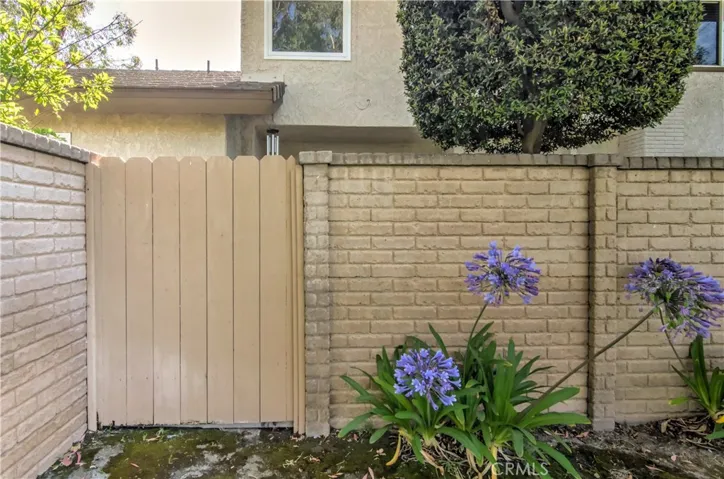 Gate and high wall offer complete privacy for patio area.