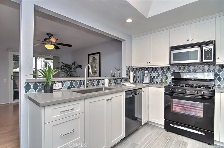 Gorgeous, completely remodeled kitchen has all the space any chef would like, plus bright white cabinetry, quartz counters and tasteful decorator details.