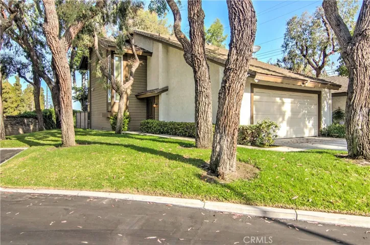 This end unit location on a tree studded greenbelt, has more curb appeal than most detached homes.