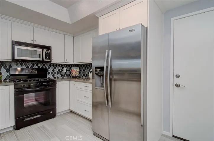 So many upgrades here...beautiful tile floors and backsplash, LED llighting...plus easy access to attached garage.