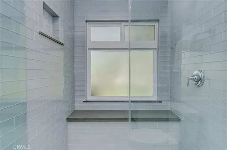 This gorgeous master shower is worthy of a five star hotel...plus the designers touch is perfect with shampoo niche, large bench, and beautiful tile details.