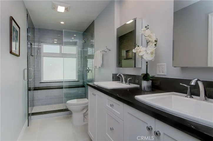 Master bath is a WOW...completely remodeled with dual sink vanity and gorgeous shower with bench seat.