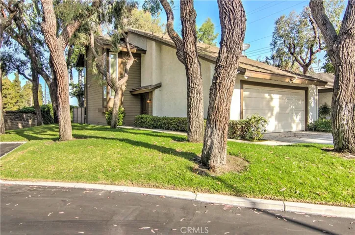 This end unit location on a tree studded greenbelt, has more curb appeal than most detached homes.