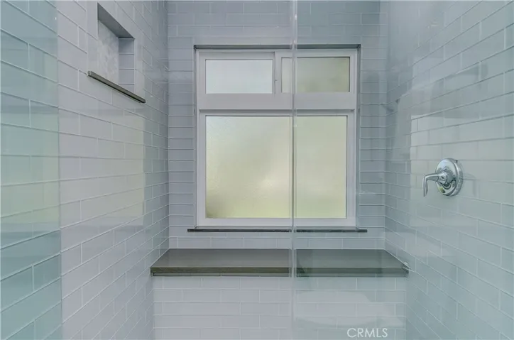 This gorgeous master shower is worthy of a five star hotel...plus the designers touch is perfect with shampoo niche, large bench, and beautiful tile details.