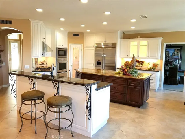 Huge CUSTOM KITCHEN with 10 ft. island, Thermador appliances, walk in panty 2 dishwashers, lots of storage and large nook with bay window that looks out to WIDE OPEN VIEWS!!