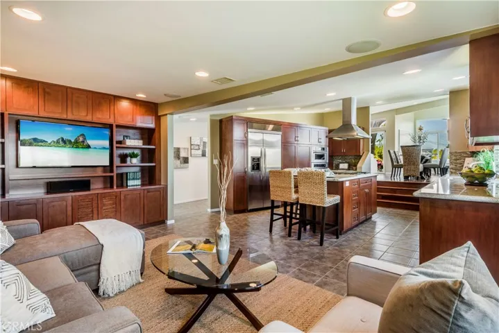 Open concept family room and kitchen with built-in media center.