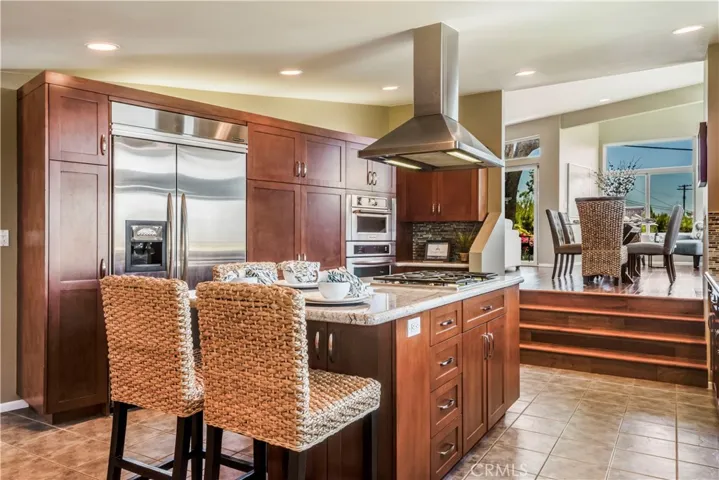 large gourmet kitchen with center island and stainless steel appliances