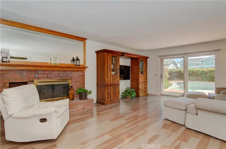Separate family room has brick fireplace and plenty of room for that 80" flat screen...slider to spa too.