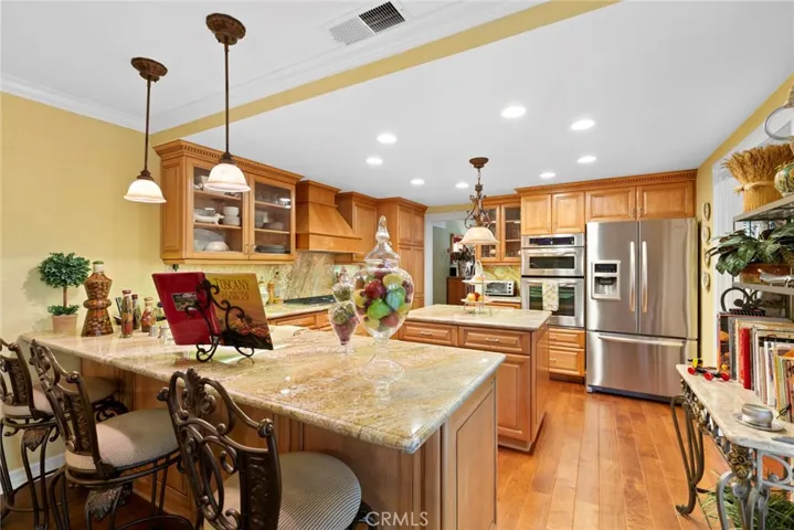 Kitchen remodeled- stainless appliances including a wine refrigerator.  Custom cabinets, pendant lighting, recessed lighting, 5 burner cooktop and beautiful distressed wood flooring.