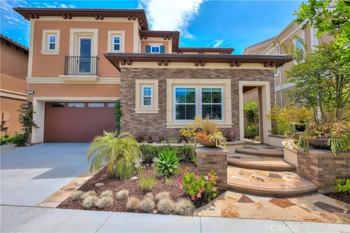 WELCOME TO 13 PEONY!!! YOUR BEAUTIFUL NEW HOME HAS WONDERFUL CURB APPEAL WITH GORGEOUS LANDSCAPING AND HARDSCAPING AND AN ABUNDANCE OF LUSH FLOWERING PLANTS.