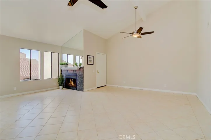 WOW is right...this is amazing living space with soaring ceilings, contemporary fans, and cozy fireplace.