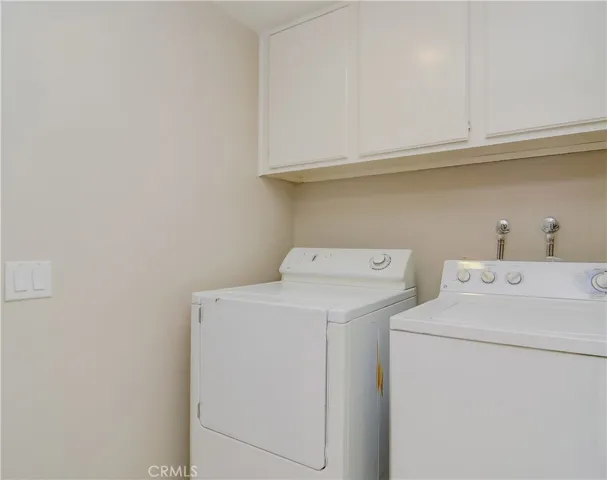 Huge laundry room has lots of storage and room for full size washer and dryer.