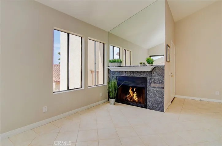 Cozy fireplace is a great place to curl up with a good book...lovely granite facing and mantle.
