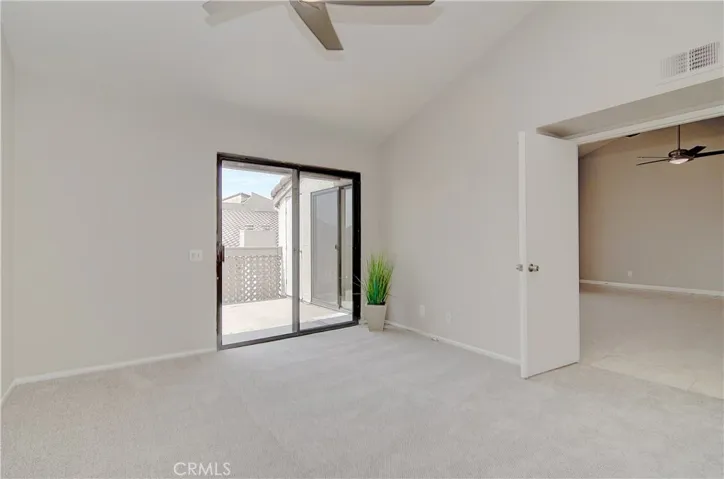Main master bedroom has vaulted ceilings and large slider to private deck.