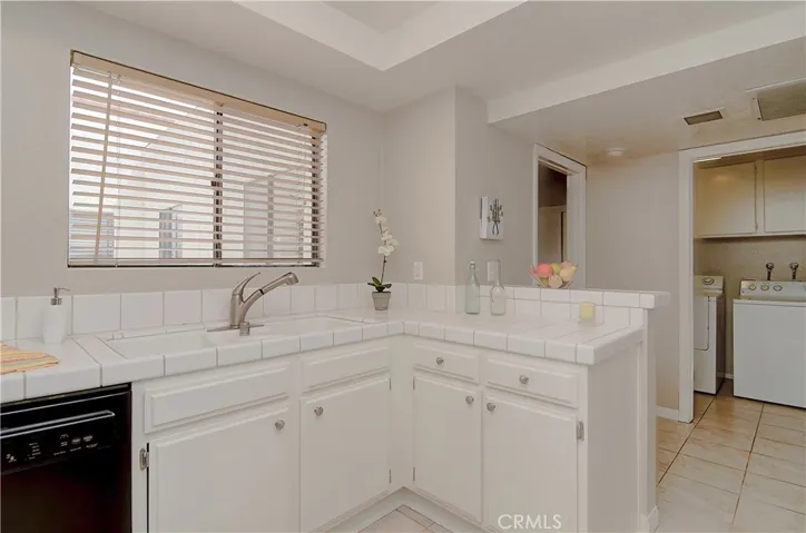 Kitchen sparkles with fresh white cabinetry, and plenty of prep space.