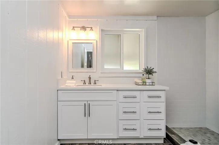 Gorgeous, remodeled master bath has large vanity with storage, huge custom shower, and beautiful tile details.