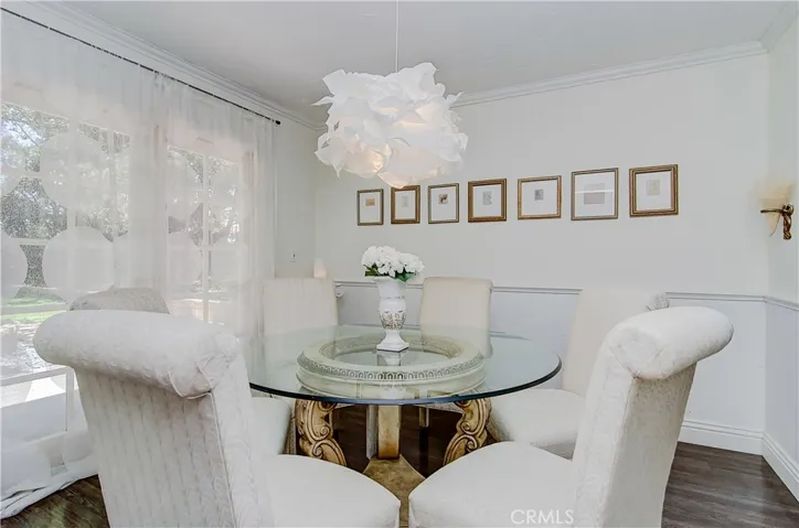 Nice details here with wainscoting, crown molding...and beautiful views of the rear yard.