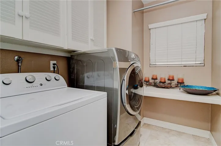 Convenient inside laundry room has everything you need to make your life easier...folding shelf...drying rack and plenty of storage...