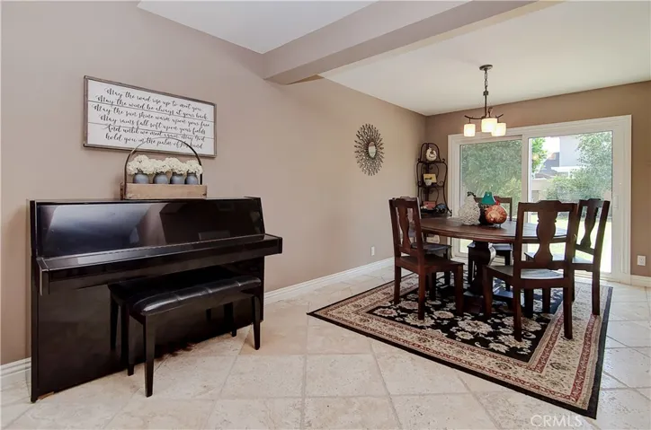 Wonderful formal dining space has plenty of room for that huge table for holiday meals...and carols around the piano...