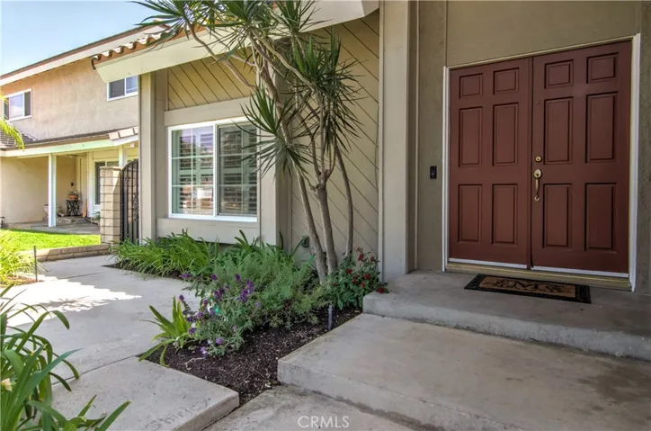 Friends and family are greeted with lovely courtyard garden and double door entry.