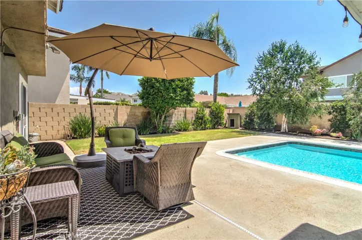 Even the dog has a pool view in this resort style back yard...plenty of space for entertaining and grassy lawn too!