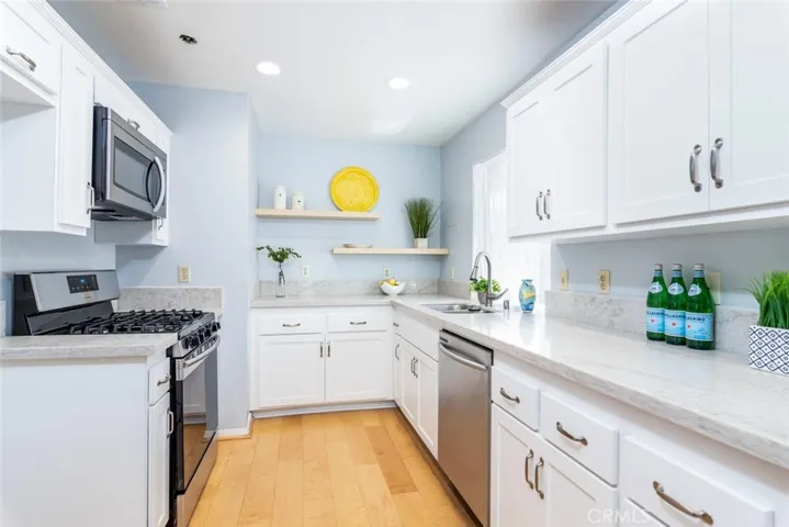 Wonderful kitchen updates. Quartz counters, Shaker style doors, stainless appliances.