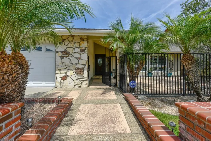 Privacy abounds behind the palms and gated courtyard entry of this upgraded single story home.