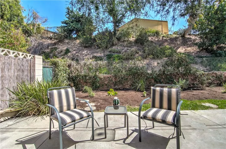 How about the backyard? Yes, I said Backyard, not just a patio slab like many others in this price range. (Hill slopes up to single family home neighborhood.)