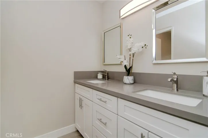 Dual vanity separated from the shower/toilet. There's no need to fuss over space in this bathroom.