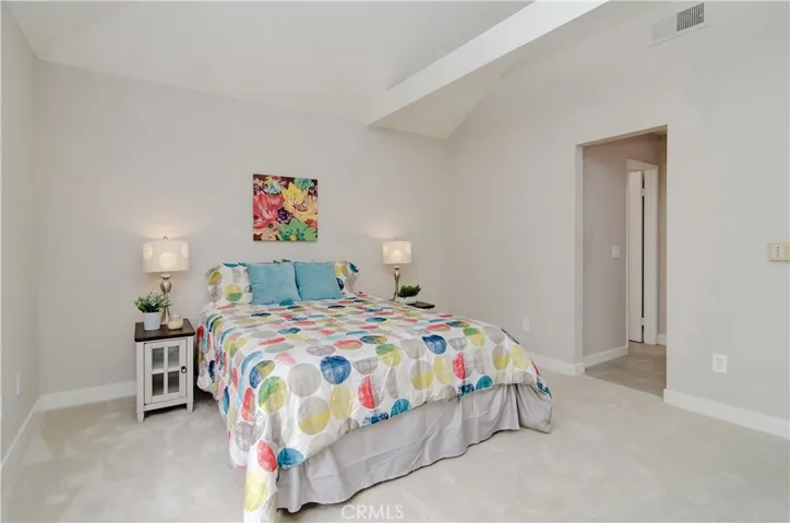 Tall beamed ceiling in this master bath. The bed here is a queen...there's room for your KING!