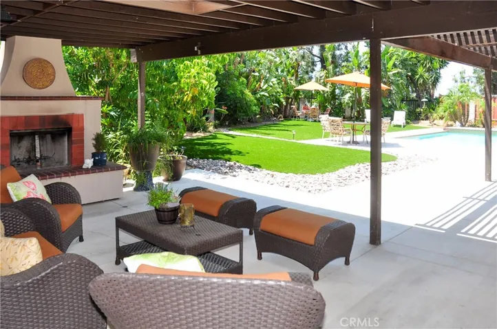 From the Fireplace/Conversation Patio, looking out towards the pool and tropical trees beyond...