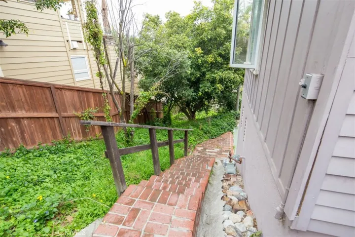 Steps leading down to lower studio/1BA unit, laundry room and garden beyond.